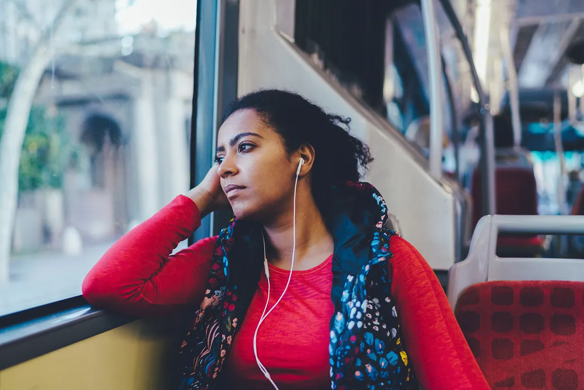 Woman looking out the window while riding the bus