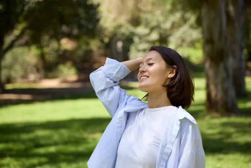 a person brushing their hair back