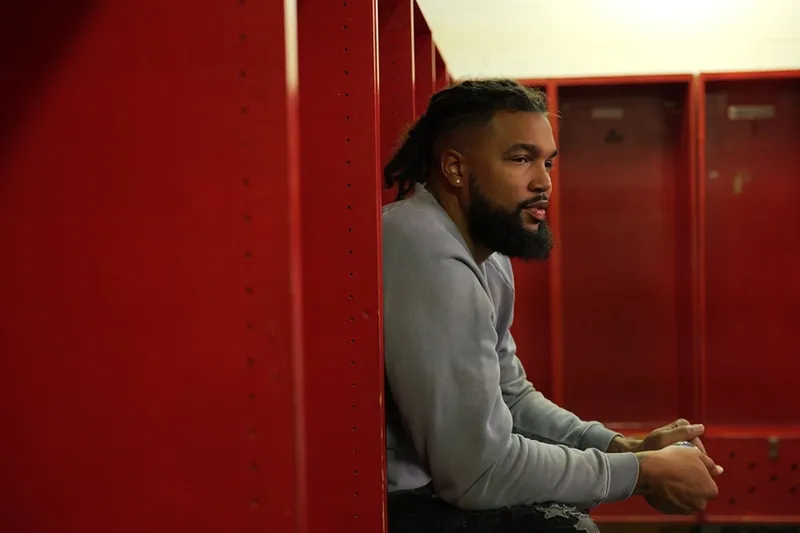 a man sitting in a locker room