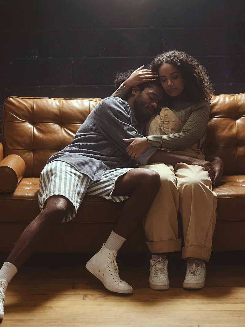 two people embrace on a couch