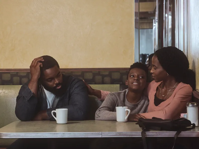 a family sitting at a cafe table